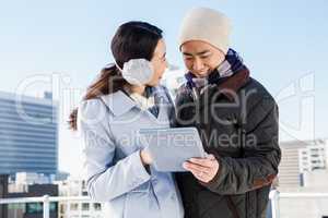 Smiling couple holding tablet computer