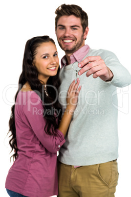 Smiling couple holding keys Smiling couple holding keys