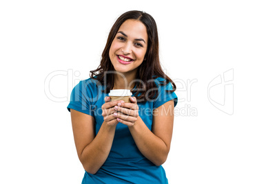 Portrait of smiling woman holding disposable coffee cup