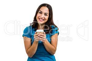 Portrait of smiling woman holding disposable coffee cup
