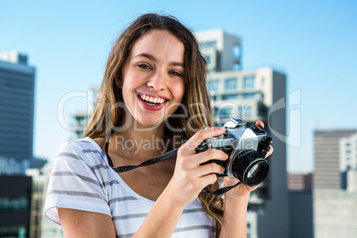 Young happy girl taking photos