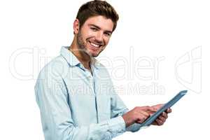 Smiling man using tablet and looking at camera