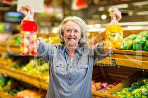 Senior happy woman holding bag of fruits