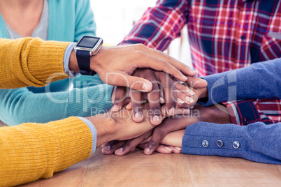 Business team stacking hands on desk