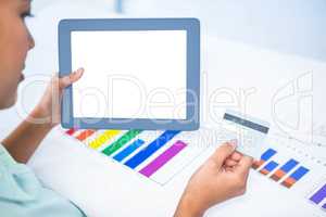 Businesswoman using her digital tablet while holding a credit ca