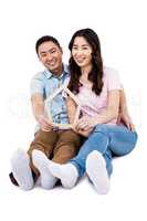 Cheerful couple holding frame
