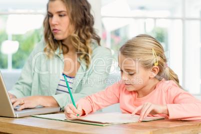 Mother and daughter working