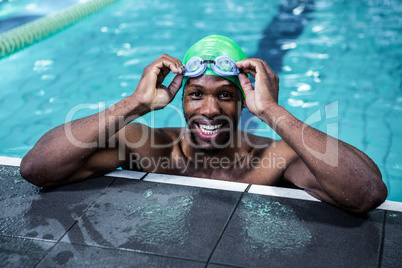 Smiling fit man in the swimming pool