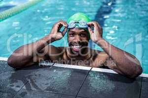 Smiling fit man in the swimming pool