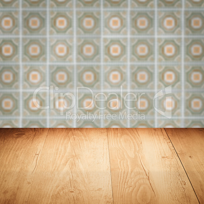 Wood table top and blur vintage ceramic tile pattern wall Wood table top and blur vintage ceramic tile pattern wall