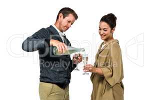 Man pouring wine in glass with smiling woman