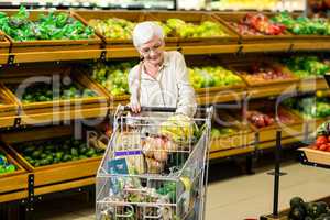 Senior woman putting banana in her trolley