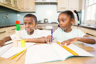 Children doing homework in the kitchen