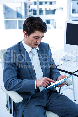 Focused asian businessman using his tablet