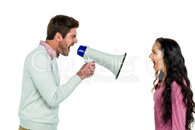 Shouting couple with man holding loudspeaker