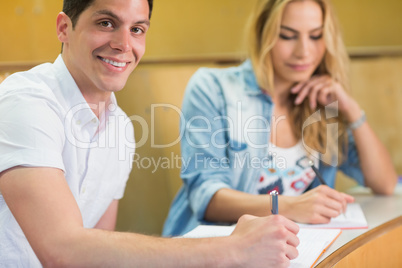 Smiling male student posing for camera