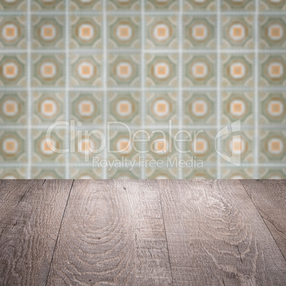 Wood table top and blur vintage ceramic tile pattern wall Wood table top and blur vintage ceramic tile pattern wall