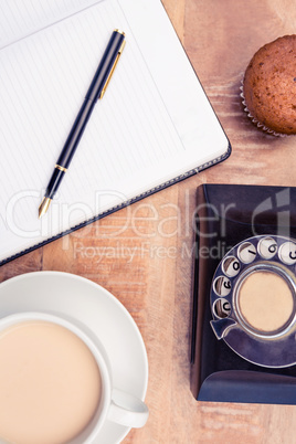 Coffee with old land line and book