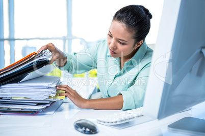 Serious businesswoman searching files