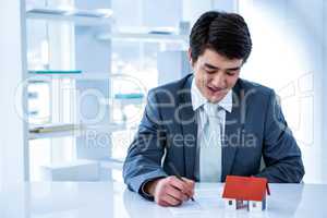 Smiling asian businessman read a estate contract