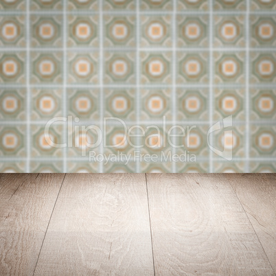 Wood table top and blur vintage ceramic tile pattern wall