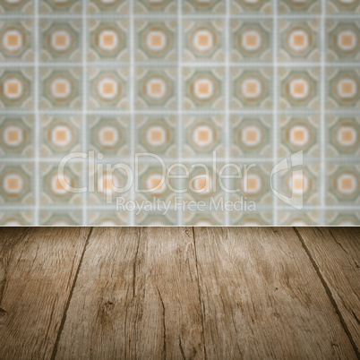 Wood table top and blur vintage ceramic tile pattern wall