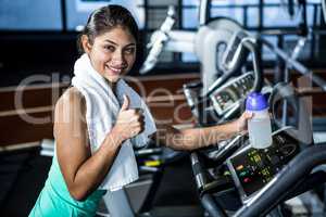 Smiling fit woman with thumbs up