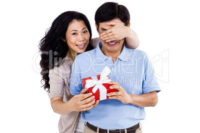 Smiling woman giving her partner a present