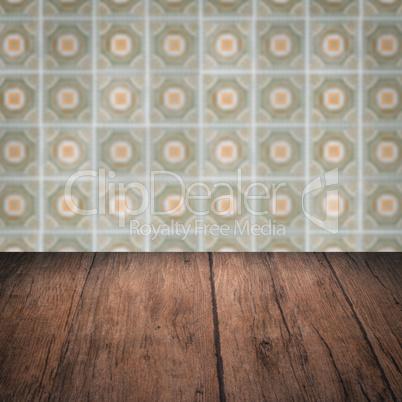 Wood table top and blur vintage ceramic tile pattern wall Wood table top and blur vintage ceramic tile pattern wall