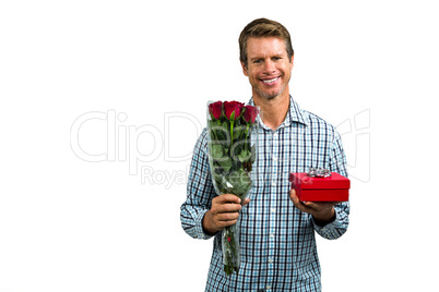 Smiling man holding bouquet of roses