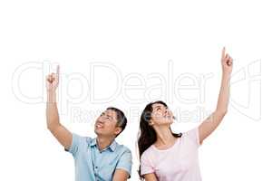 Happy young couple pointing up