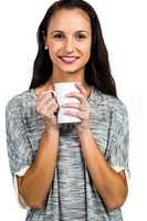 Attractive woman holding white cup smiling at camera