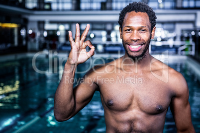 Fit swimmer gesturing ok sign