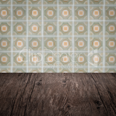 Wood table top and blur vintage ceramic tile pattern wall