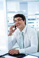 Smiling asian businessman talking on the phone
