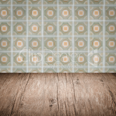 Wood table top and blur vintage ceramic tile pattern wall