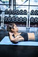 Concentrated fit woman doing sit ups