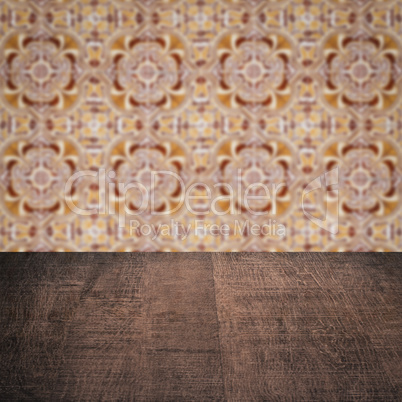 Wood table top and blur vintage ceramic tile pattern wall