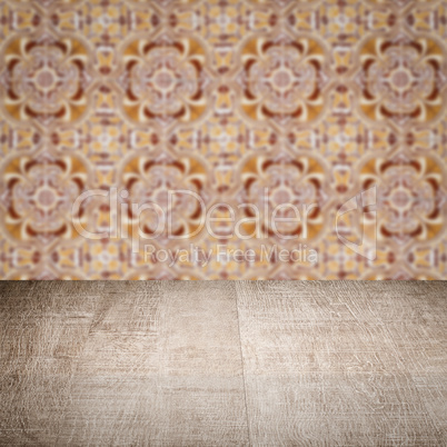 Wood table top and blur vintage ceramic tile pattern wall Wood table top and blur vintage ceramic tile pattern wall