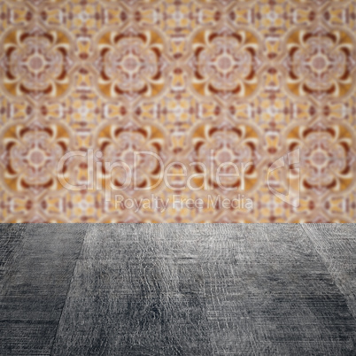 Wood table top and blur vintage ceramic tile pattern wall