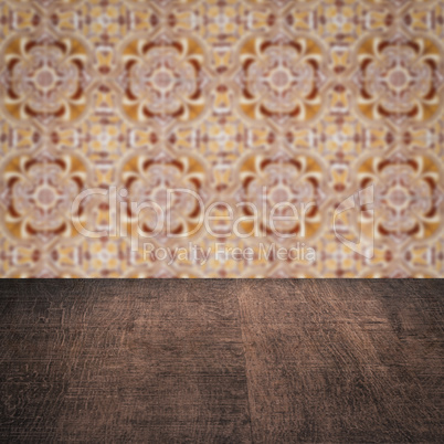 Wood table top and blur vintage ceramic tile pattern wall