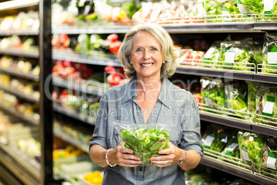 Senior woman picking out some vegetables