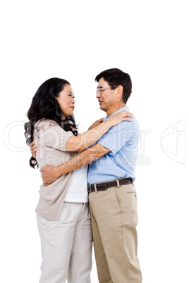 Smiling couple holding each other