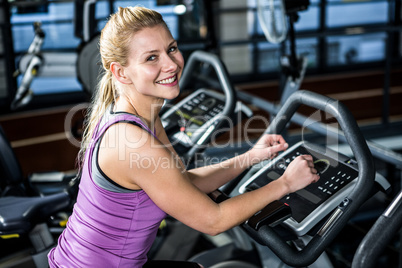 Smiling woman doing bike exercise Smiling woman doing bike exercise