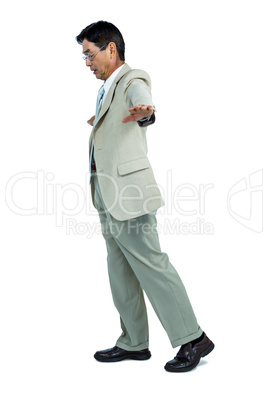 Focused businessman walking straight ahead