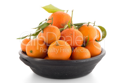 Tangerines on clay bowl