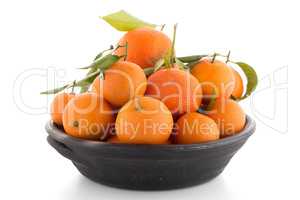 Tangerines on clay bowl