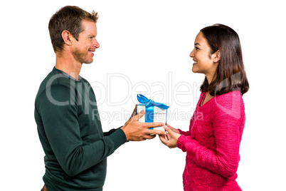 Smiling couple holding gift box