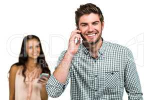 Cheerful couple using smartphones