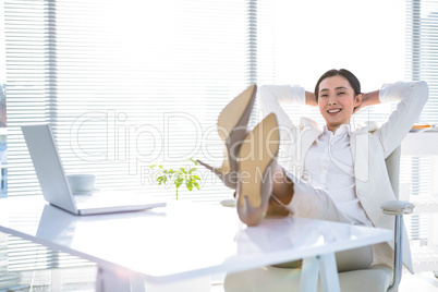 Relaxed businesswoman sitting with her feet up